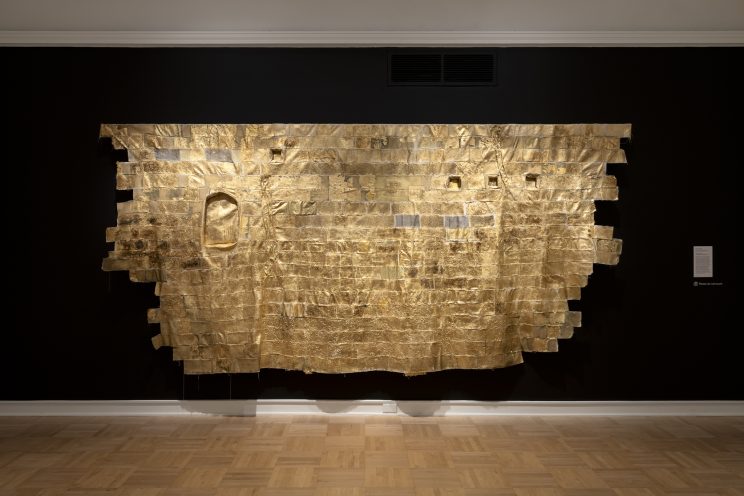 <p>Namita Paul (U.S., b. 1970). <em>Testimony</em>. 2023. Canvas, thread, gold leaf, paint, lentils, wheat berries, assorted textiles, photo transfer. Courtesy of the artist. [Installation view, <em>Spirit House</em>, Henry Art Gallery, University of Washington, Seattle. 2025]. Photo: Jueqian Fang. </p>
