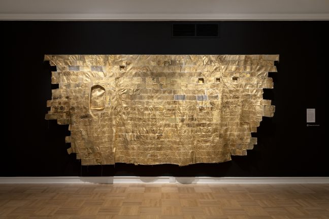 <p>Namita Paul (U.S., b. 1970). <em>Testimony</em>. 2023. Canvas, thread, gold leaf, paint, lentils, wheat berries, assorted textiles, photo transfer. Courtesy of the artist. [Installation view, <em>Spirit House</em>, Henry Art Gallery, University of Washington, Seattle. 2025]. Photo: Jueqian Fang. </p>
