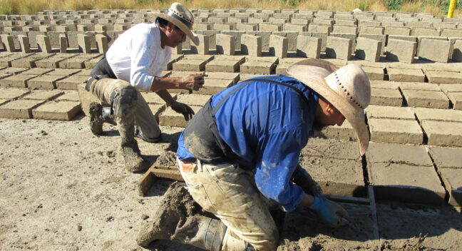 <p>rafa esparza making adobe bricks with his father, Ramón Esparza</p>
